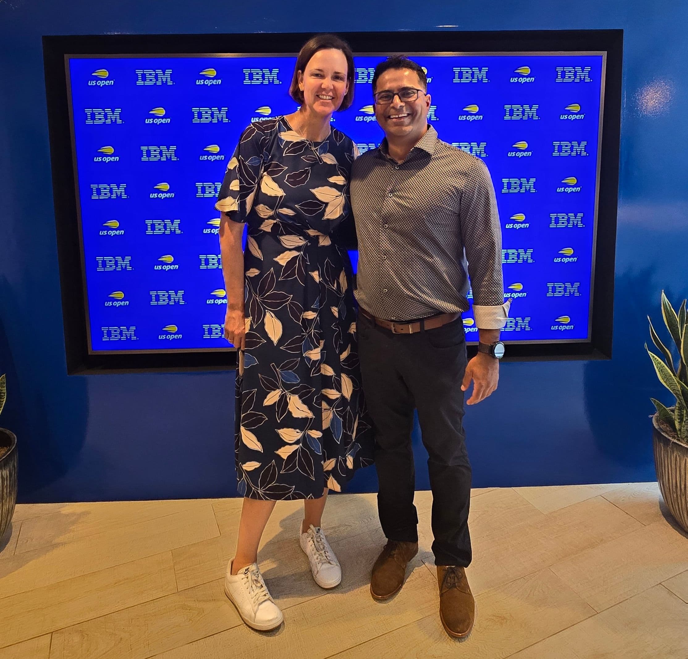 Sachin and Lindsay Davenport full length smiling in front of a TV